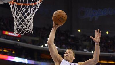 Los Angeles Clippers forward Blake Griffin, left, goes up for a dunk against the Detroit Pistons during the first half of their game on Saturday, March 22, 2014, in Los Angeles. Mark J Terrill / AP Photo
