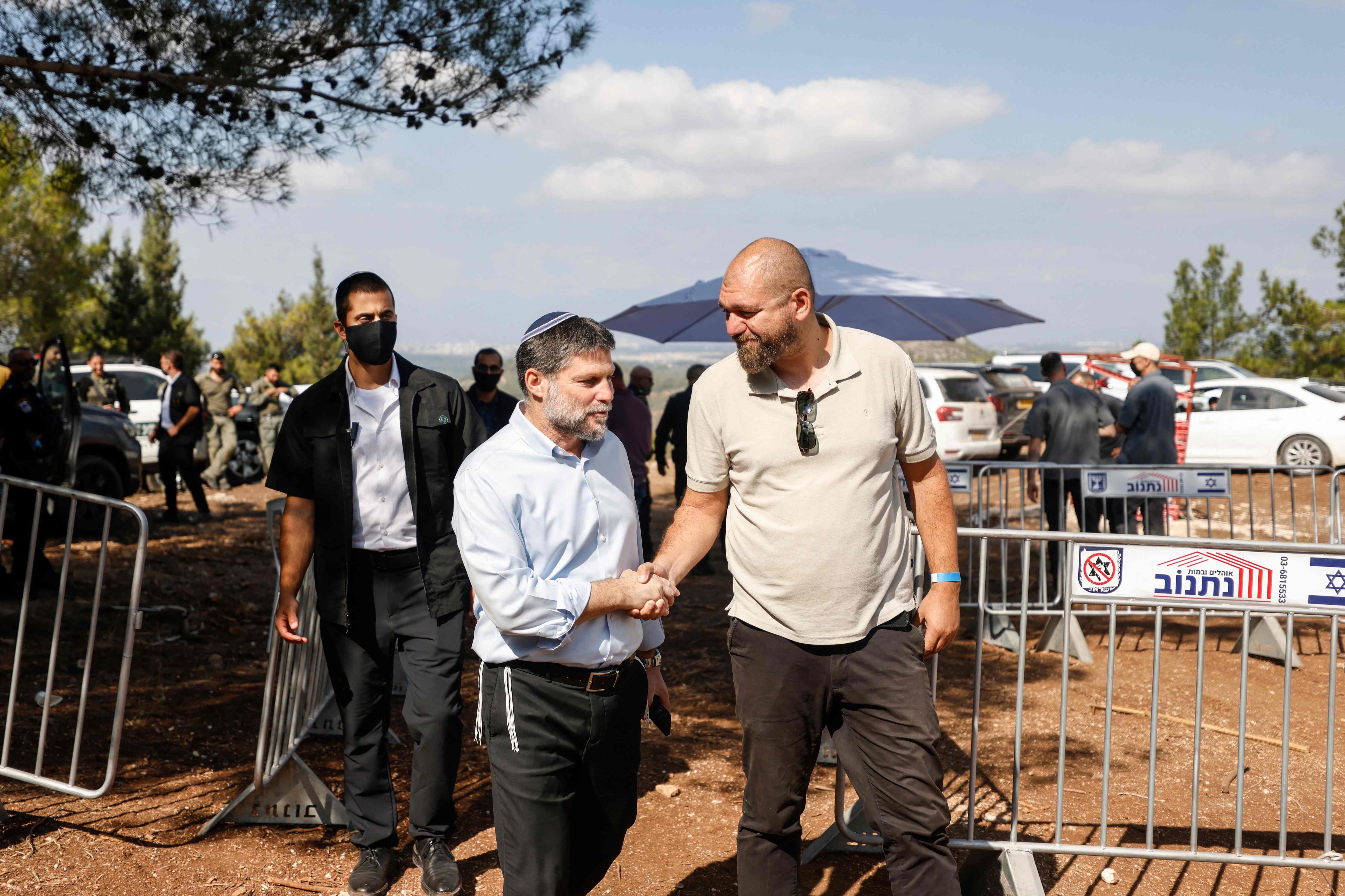 Far-right Finance Minister and leader of the Religious Zionist Party, Bezalel Smotrich, centre, arrives for a party meeting organised on a hill overlooking the northern Arab-Israeli town of Majd Al Kurum on September 24. AFP