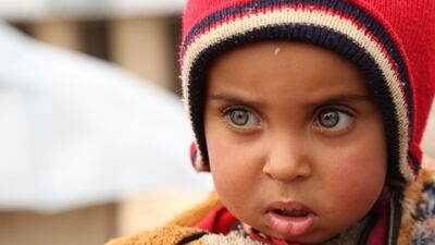 A child stands at a new refugee camp set up for Iraqis, mostly fleeing the northern city of Mosul, now held by the Islamic State (IS) group, on the outskirts of the Syrian town of Ras al-Ain, near the border with Turkey. Delil Souleiman / AFP