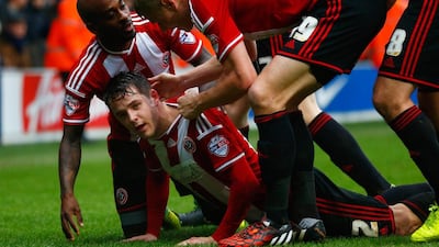Marc McNulty of Sheffield United, second left, celebrates with teammates after scoring their first goal in a 3-0 away win in the FA Cup third round of Queens Park Rangers on Sunday at Loftus Road. Julian Finney / Getty Images