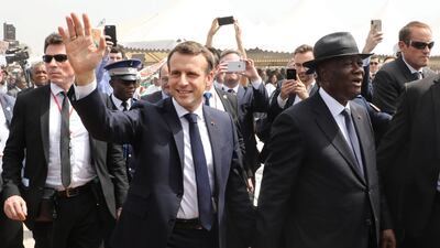 French President Emmanuel Macron, left, and Ivorian President Alassane Ouattara arrive at a ceremony to lay the first brick of the future Bouake market on December 22, 2019. AFP