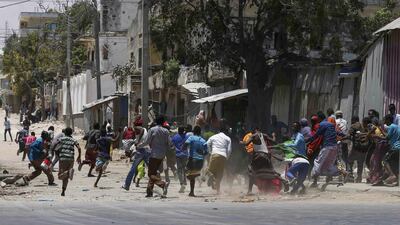 Civilians flee as Somali security forces battle Al Shabab fighters who stormed a government building after exploding a car bomb in central Mogadishu, one of a series of attacks the extremist group has carried out in the Somali capital. EPA