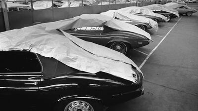 A line of Jaguar E-types under dust sheets are seen at the company's factory, Coventry, in 1972. Getty Images