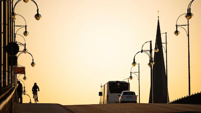 A cyclist pedals on the Theodor Heuss Bridge during a moderate rush hour due to restrictions designed to slow down the spread of the new coronavirus in Mainz, Germany. AP Photo