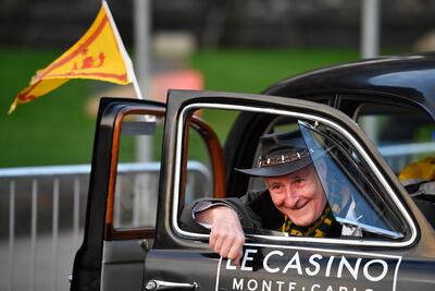 Members of the public interact with classic cars ahead of the Monte Carlo rally in Paisley, Scotland. Getty Images