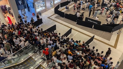 Crowds wait in line at the Dubai Mall Apple Store. Antonie Robertson / The National