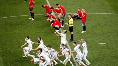 Russia players celebrate winning the penalty shootout against Spain in their round of 16 match. Maxim Shemetov / Reuters