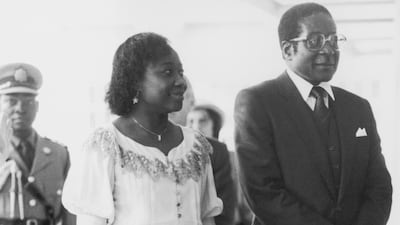 Robert Mugabe, the prime minister of Zimbabwe, visits Queen Elizabeth at Buckingham Palace in London with his wife Sally on May 20, 1982. Rob Taggart / Central Press / Hulton Archive / Getty Images