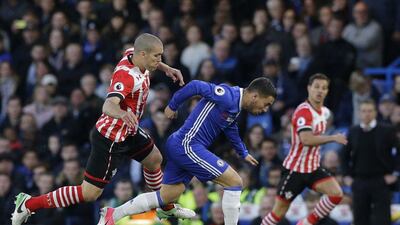 Chelsea forward Eden Hazard rides a challenge from Southampton midfielder Oriol Romeu. Alastair Grant / AP Photo