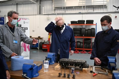 Britain's Prime Minister Boris Johnson visits the automotive shop during a visit to Kirklees College. Reuters