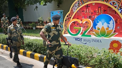 Indian paramilitary soldiers with a sniffer dog frisk the area near the venue ahead of this week's summit of the Group of 20 nations, in New Delhi, India. AFP