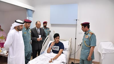 Members of Ajman Police paid a visit to patients receiving treatment in hospital after a water contamination outbreak in Ajman. Courtesy Ajman Police