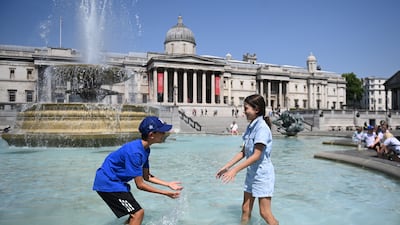 Children play in a fountain in Trafalgar Square in London during a heatwave which saw the UK endure its hottest day on record, with temperatures breaching 40C for the first time. EPA