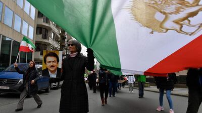 Demonstrators hold Iranian flags at a protest backing the Iranian resistance movement outside the EU headquarters in Brussels. AFP