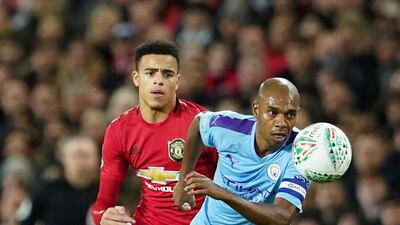 Manchester City's Fernandinho, right, vies for the ball with Manchester United's Daniel James during the League Cup semi-final first leg at Old Trafford. AP