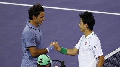 Kei Nishikori, right, of Japan shakes hands with Roger Federer of Switzerland after Nishikori defeated Federer during a quarter-final match at the Miami Masters on Wednesday. Erik S Lesser / EPA / March 26, 2014