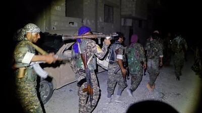 US-backed Syrian Democratic Forces (SDF) fighters walk towards the frontline in Raqqa, north-east Syria, on June 22, 2017. Hussein Malla / AP