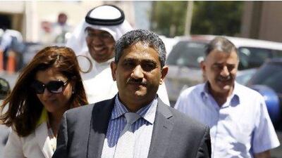 Mansoor al Jamri, former editor-in-chief of the Bahraini opposition newspaper Al Wasat (front), his wife, Reem Khalifa, who is also a journalist in Bahrain, the British former managing editor at Al Wasat, Walid Noueihed (right), and the former head of local news at Al Wasat, Aqeel Mirz,a arrive at a court in Manama yesterday. Hamad I Mohammed / Reuters