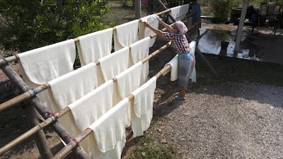 Sheets of rubber just processed on a drying rack are hung at a workshop in Rayong, Thailand. Paula Bronstein / Getty Images