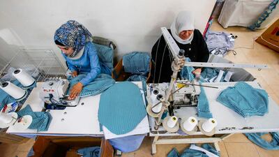Seamstresses work hard to complete the orders. AFP