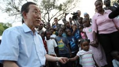 Ban Ki-moon greets children at the Pétionville Club golf course this week. Mr Ban warned that makeshift camps such as theirs will not be safe in the rainy season.