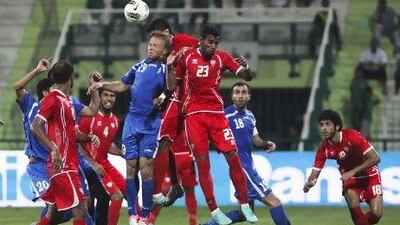 The UAE, in red, and Uzbekistan drew 2-2 in a friendly international at Al Shabab's stadium in Dubai last night. Lee Hoagland/The National