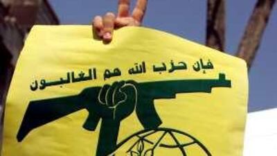 A student flashes the victory sign as he holds the flag of the Lebanese militant group Hizbollah, a key ally of Mahmoud Ahmadinejad, Iran's president, during a protest against the 60th anniversary of the establishment of the state of Israel, outside the British embassy in Tehran in 2008.
