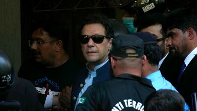 Pakistan's former prime minister Imran Khan is escorted by police to the high court in Islamabad. AP