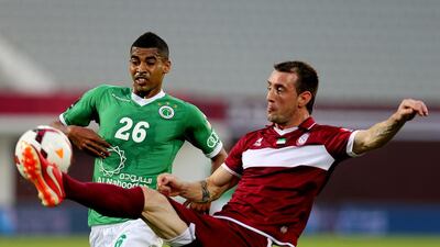 Hassan Ibrahim, left, of Al Shabab, vies for the ball with Al Wahda's Damian Diaz in Abu Dhabi on Wednesday night. Satish Kumar / The National