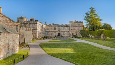 Cottages and a tennis court surround the central structure, and the grounds also list facilities such as a gym, hot tub and sauna