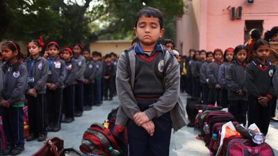 Schoolchildren in New Delhi observe a two-minute silence for victims killed in a Taliban attack on a military-run school in Peshawar, yesterday. Altaf Qadri / AP Photo