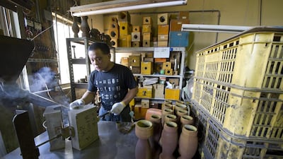 A worker makes moulds for metal casting at the Nousaka metal crafts factory. Everett Kennedy Brown / EPA