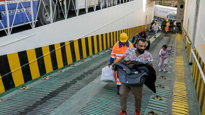 People displaced from Lebanon board a ship bound for Turkey at the port of the northern city of Tripoli. AFP
