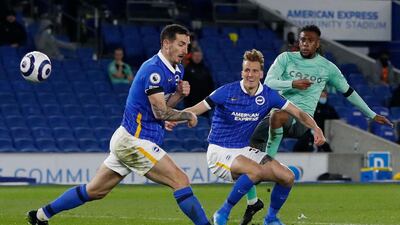 Everton's Nigerian midfielder Alex Iwobi (R) shoots on goal during the English Premier League football match between Brighton and Hove Albion and Everton at the American Express Community Stadium in Brighton, southern England. AFP