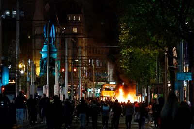 A bus burns during an anti-immigration demonstration after children were injured in a stabbing in Dublin on November 23. Reuters