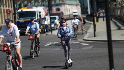 Electric scooters alongside bicycles are an increasingly common sight on UK roads. Getty