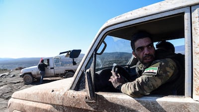 Turkish-backed Syrian rebel fighters are seen as they drive toward the Turkish-Syrian border on January 30 this year. Ozan Kose / AFP