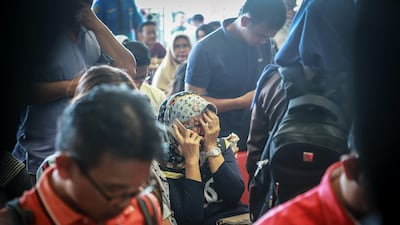 Family members react at Pangkal Pinang airport. AFP