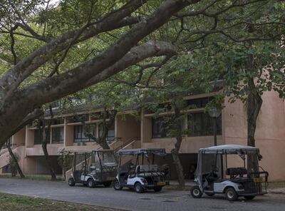 Golf carts stand parked in front of a low-rise building in Discovery Bay. Justin Chin/Bloomberg
