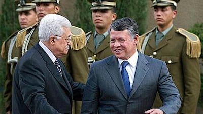 Mahmoud Abbas, president of the Palestinian Authority, left, and King Abdullah II of Jordan walk past an honour guard prior to their meeting in the West Bank city of Ramallah yesterday. The monarch’s trip comes as the leaders seek rapprochement with the Islamic militant group Hamas.