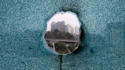 A shattered window is seen during an operation to evacuate the Hong Kong Polytechnic University. REUTERS