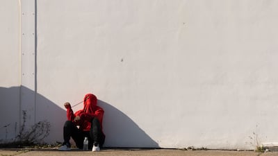 A migrant man waits to be processed by the UK Border Force, after arriving on Dungeness beach. Getty Images