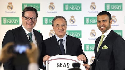 Real Madrid’s president Florentino Perez, centre, Alex Thursby, the chief executive of National Bank of Dhabi, left and Abdulla bin Khalaf Al Otaiba, NBAD’s senior general manager of domestic banking, during the official presentation of the sponsorship agreement. Hugo Ortuno / EPA