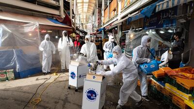 Workers spray disinfectant as a precaution against covid-19 at Saemaeul traditional market in Seoul, South Korea. EPA