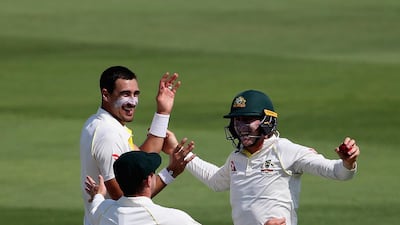 Marnus Labuschagne, wearing the helmet, celebrates the wicket of Mohammad Hafeez of Pakistan during day one of the Second Test match between Australia and Pakistan at Zayed Cricket Stadium. Francois Nel / Getty Images