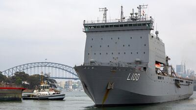 In this photo provided by the Australian Department of Defense, HMAS Choules departs from a fleet base in Sydney. Australia is deploying military ships to help communities ravaged by wildfires that destroyed homes and sent thousands of residents and holidaymakers fleeing to the shoreline. AP
