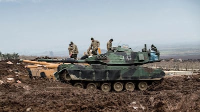 Turkish soldiers train with their tanks and armored vehicles near Syrian-Turkish border earlier this week. EPA