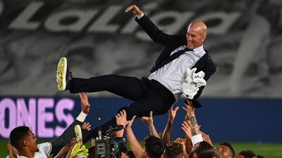 Real Madrid's player lift manager Zinedine Zidane after winning the La Liga title following their win over Villarreal at the Alfredo Di Stefano Stadium on Thursday. AFP