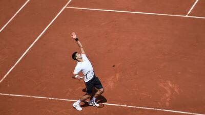 Serbia’s Novak Djokovic serves to Australia’s Thanasi Kokkinakis during the men’s third round at the Roland Garros 2015 French Tennis Open in Paris on May 30, 2015. AFP PHOTO / PASCAL GUYOT