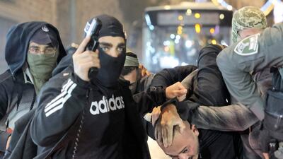 Israeli troops drag away a Palestinian protester. AFP